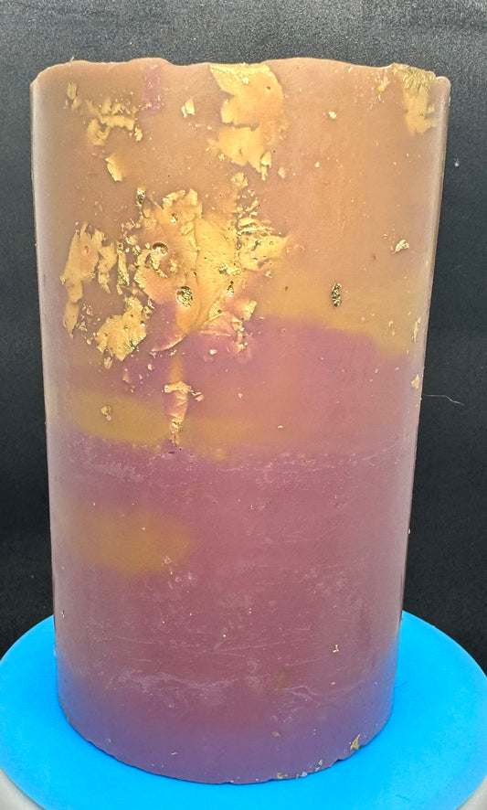 Blended gold and purple pillar candle